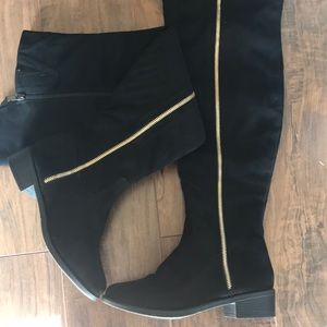 Thigh high black suede boots with the gold zipper